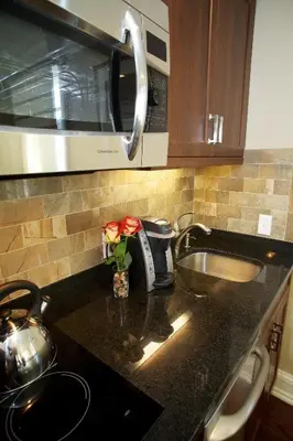 a kitchen counter with a sink and a microwave at Norwalk Inn & Conference Center in Norwalk