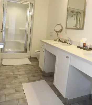 a bathroom with a shower and a sink and a toilet at Norwalk Inn & Conference Center in Norwalk
