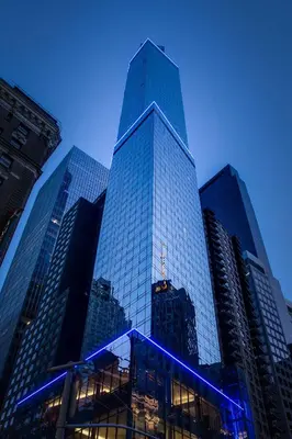 a tall glass skyscraper with blue lights on it at Residence Inn by Marriott New York Manhattan/Central Park in New York