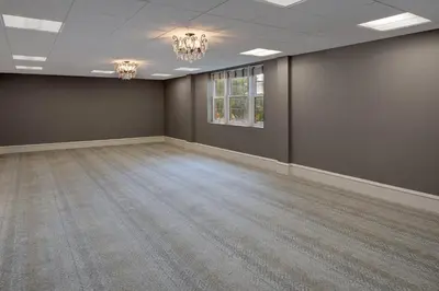 an empty room with brown walls and a chandelier at The Westin Governor Morris, Morristown in Morristown