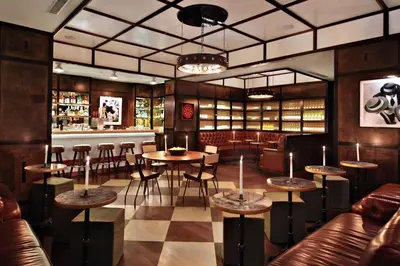 a restaurant with tables and chairs and a bar at Gild Hall, A Thompson Hotel, by Hyatt in New York
