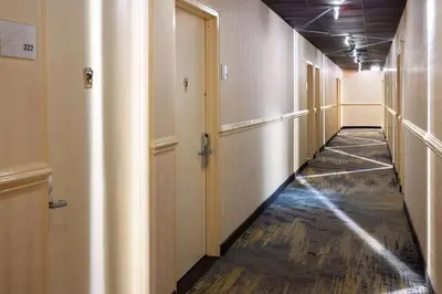 a corridor of an office building with a long hallway at Ramada by Wyndham Bronx in Bronx