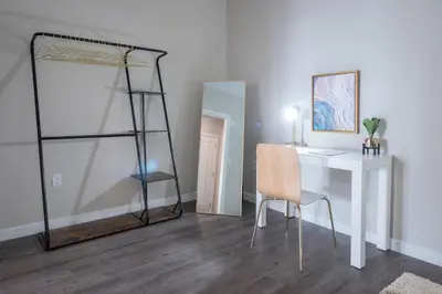 a room with a desk and a chair and a mirror at Luxury Furnished Apartments by Hyatus Downtown at Yale in New Haven