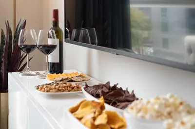 a table with a bottle of wine and plates of food at Luxury Furnished Apartments by Hyatus Downtown at Yale in New Haven