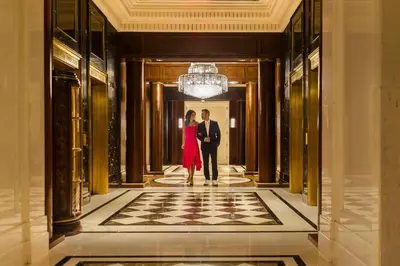 a man and a woman walking down a hallway at JW Marriott Essex House New York in New York