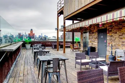a patio with tables and chairs on a building at The Ridge in New York