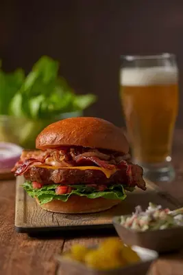 a sandwich on a table with a glass of beer at Hyatt Place Milford/New Haven in Milford