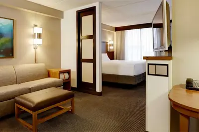 a hotel room with a bed and a couch at Hyatt Place Milford/New Haven in Milford