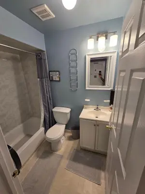 a bathroom with a toilet and a sink and a shower at 500 Estates LLC in Irvington