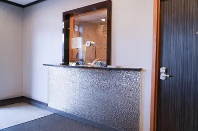 a bathroom with a sink and a mirror at Cabana Hotel Yankee Stadium in Bronx