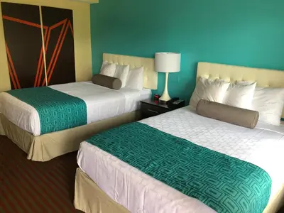 a hotel room with two beds in a room at Howard Johnson by Wyndham Rocky Hill in Rocky Hill