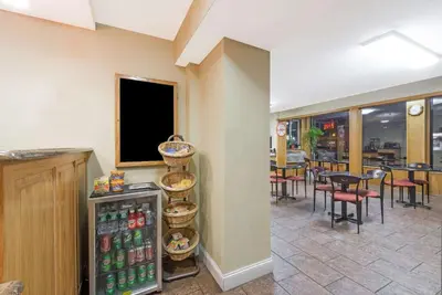 a restaurant with a drink cooler in a room at Howard Johnson by Wyndham Rocky Hill in Rocky Hill