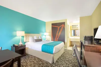 a hotel room with a bed and a television at Howard Johnson by Wyndham Rocky Hill in Rocky Hill