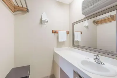 a bathroom with a sink and a mirror at Howard Johnson by Wyndham Rocky Hill in Rocky Hill