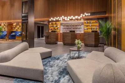 a hotel lobby with two couches and a bar at NH Collection New York Madison Avenue in New York