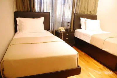 a hotel room with two beds and a phone at Off SoHo Suites Hotel in New York