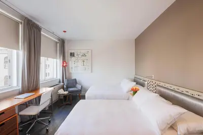 a hotel room with two beds and a desk at NU Hotel in Brooklyn