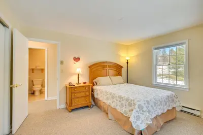 a bedroom with a bed and a window and a toilet at Homey Windham Condo Hike and Ski the Catskill Mtns! in Windham
