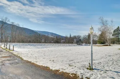 a street light in the snow next to a field at Homey Windham Condo Hike and Ski the Catskill Mtns! in Windham