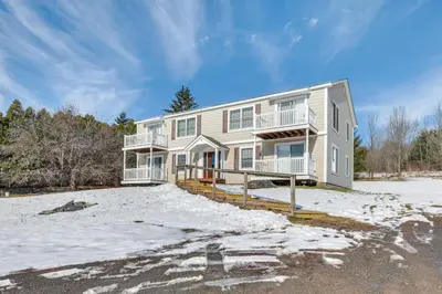 a large house with snow on the ground at Homey Windham Condo Hike and Ski the Catskill Mtns! in Windham