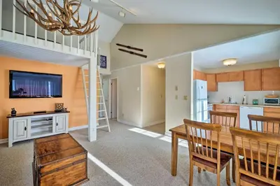 a kitchen and dining room with a loft bed and a dining table at Condo with Loft 2 Mi to Windham Mountain Ski! in Windham