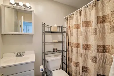 a bathroom with a toilet and a sink and a mirror at Condo with Loft 2 Mi to Windham Mountain Ski! in Windham