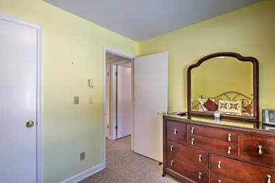 a bedroom with a dresser with a mirror on it at Condo with Loft 2 Mi to Windham Mountain Ski! in Windham