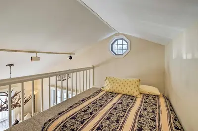 a bedroom with a bed with a pillow on it at Condo with Loft 2 Mi to Windham Mountain Ski! in Windham