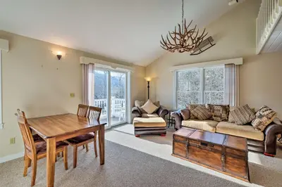 a living room with a couch and a table at Condo with Loft 2 Mi to Windham Mountain Ski! in Windham