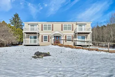 a large house in the snow in the yard at Condo with Loft 2 Mi to Windham Mountain Ski! in Windham