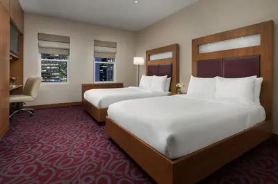 a hotel room with two beds and a desk at Hotel 57 in New York