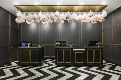 a lobby with desks and a chandelier at Hotel 57 in New York