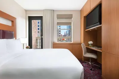 a hotel room with a bed and a desk and a window at Hotel 57 in New York