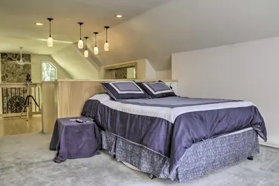 a bedroom with a large bed with purple sheets at Spacious Home with Deck, Grill and Delaware River View in Callicoon