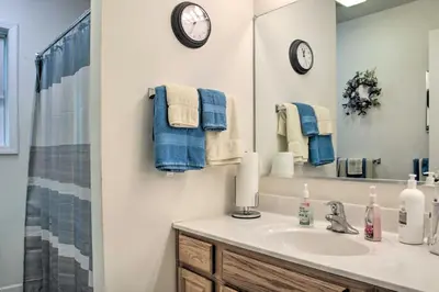 a bathroom with a sink and a mirror at Spacious Home with Deck, Grill and Delaware River View in Callicoon