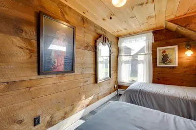 a bedroom with wooden walls and two beds in it at Johns Farmhouse in Mount Snow on 120 Acres! in Whitingham