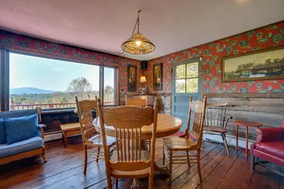 a dining room with a table and chairs and a window at Johns Farmhouse in Mount Snow on 120 Acres! in Whitingham