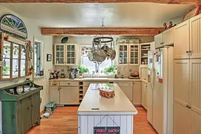 a kitchen with white cabinets and a white counter top at Stamford Lakefront Home with Dock and Wraparound Deck! in Stamford