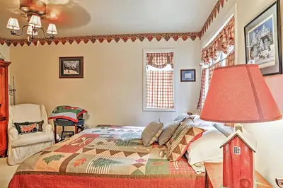 a bedroom with a bed and a lamp and a window at Stamford Lakefront Home with Dock and Wraparound Deck! in Stamford
