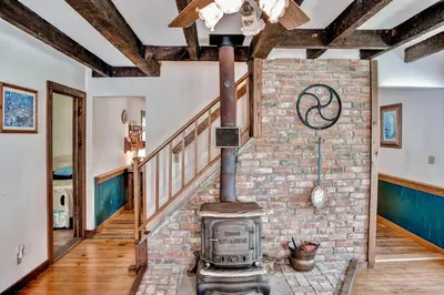 an old brick wall with a wood stove in a room at 5 Mi to Cooperstown All Star Village Otego Home in Otego