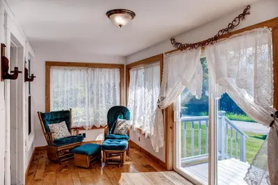 a room with two chairs and a large window at 5 Mi to Cooperstown All Star Village Otego Home in Otego