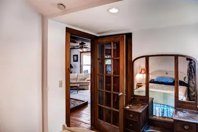 a room with a mirror and a bedroom with a bed at 5 Mi to Cooperstown All Star Village Otego Home in Otego