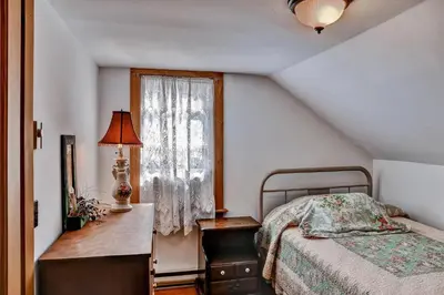 a bedroom with a bed and a dresser and a window at 5 Mi to Cooperstown All Star Village Otego Home in Otego