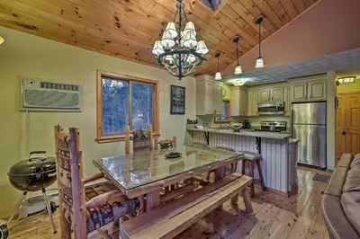 a kitchen with a wooden ceiling and a large table at Jewett Cabin with Viewing Deck - 10 Mins to Skiing! in Jewett