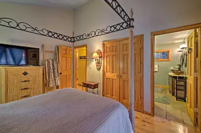 a bedroom with a bed and a tv in a room at Jewett Cabin with Viewing Deck - 10 Mins to Skiing! in Jewett
