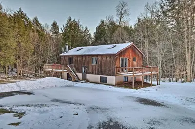 a log cabin in the woods in the snow at Jewett Cabin with Viewing Deck - 10 Mins to Skiing! in Jewett
