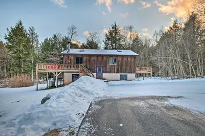 a log cabin in the snow with a snow pile at Jewett Cabin with Viewing Deck - 10 Mins to Skiing! in Jewett