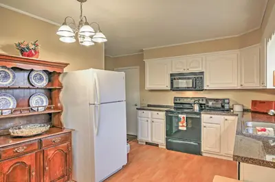 a kitchen with white cabinets and a white refrigerator at Serene Retreat - 7 Mi to All Star Village in Otego