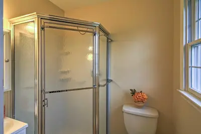 a bathroom with a toilet and a glass shower at Serene Retreat - 7 Mi to All Star Village in Otego