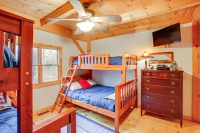 a bedroom with two bunk beds and a ceiling fan at 1 Mi to Mt Snow Luna Stella Home with Fireplace in West Dover
